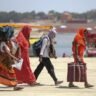 Women walk along a roadside under intense heatwave conditions in India.