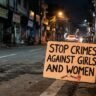 Placard reading "Stop Crimes Against Girls and Women" on a street symbolising outrage over the Sri Ganganagar minor rape case in Rajasthan.