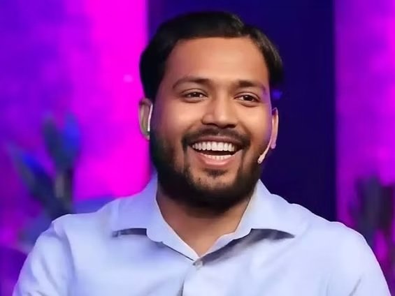 Khan Sir smiling during a public appearance