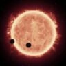 Artist's impression of a red dwarf star with Earth-sized planets. Scientists have found evidence that some red dwarfs may have consumed rocky planets.