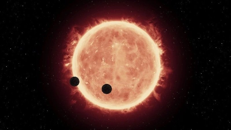 Artist's impression of a red dwarf star with Earth-sized planets. Scientists have found evidence that some red dwarfs may have consumed rocky planets.