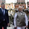 Prime Minister Narendra Modi and Slovak Prime Minister Robert Fico inspect a guard of honour during Modi's visit to Bratislava, Slovakia.