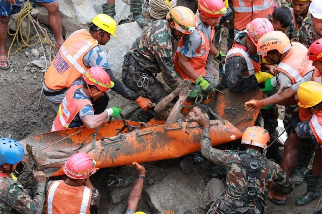 Rescue teams pull a trapped worker from a hydropower tunnel in Nepal