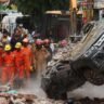 Delhi building collapse rescue workers search rubble in Satya Niketan