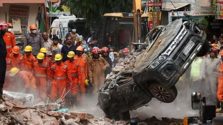 Delhi building collapse rescue workers search rubble in Satya Niketan