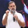 Rahul Gandhi speaks at a public event while holding a microphone