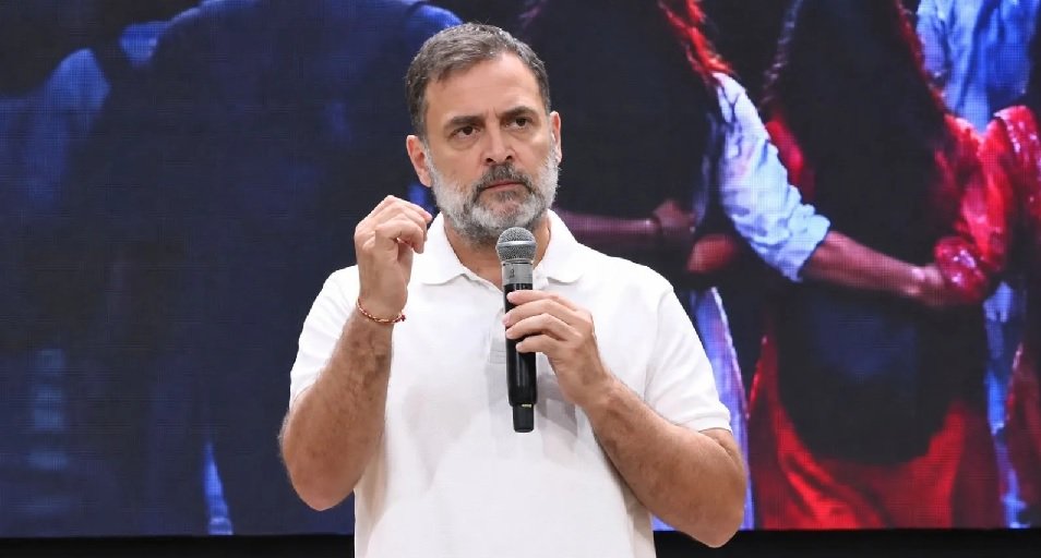 Rahul Gandhi speaks at a public event while holding a microphone