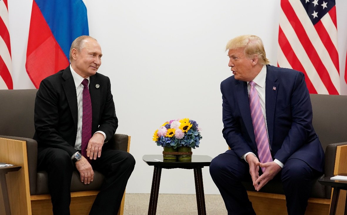Donald Trump and Vladimir Putin seated together during a meeting