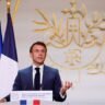 French government official speaking at a podium during a national education and budget announcement