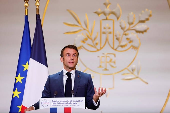 French government official speaking at a podium during a national education and budget announcement